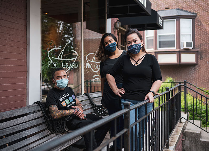 from left, pho grand servers anh tuan nguyen and arny wichaya and owner tami trinh 