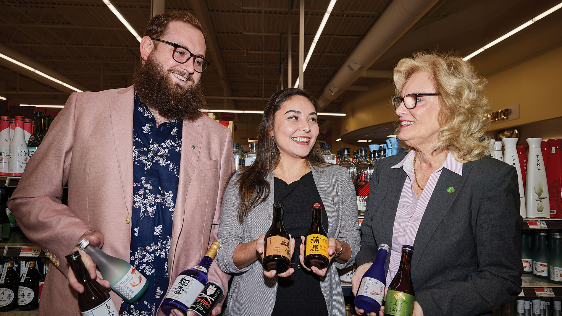 from left: andrew lamb, kira webster and patricia wamhoff shop for sake at pan-asia supermarket