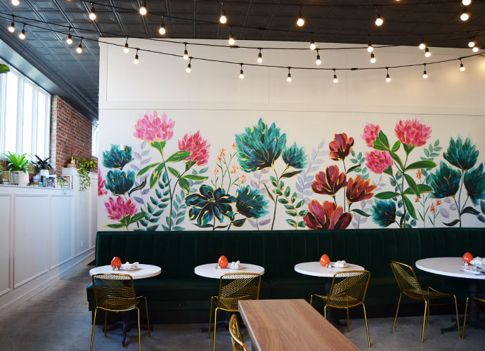 Local artist Marissa Todd painted The Clover and the Bee’s signature floral mural. 