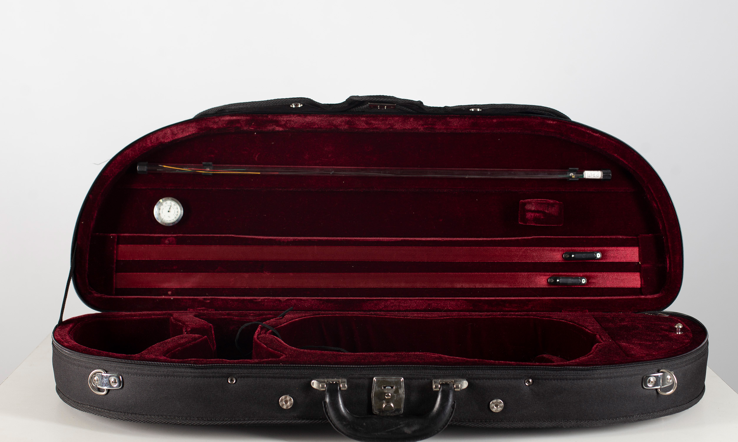 A violin case, branded JTL