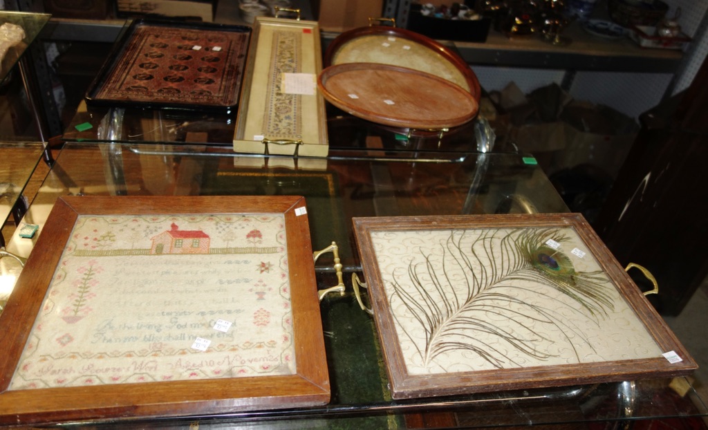 A group of assorted early 20th century trays, including wooden examples with inset textiles, an Oriental lacquer tray and sundry. (qty)