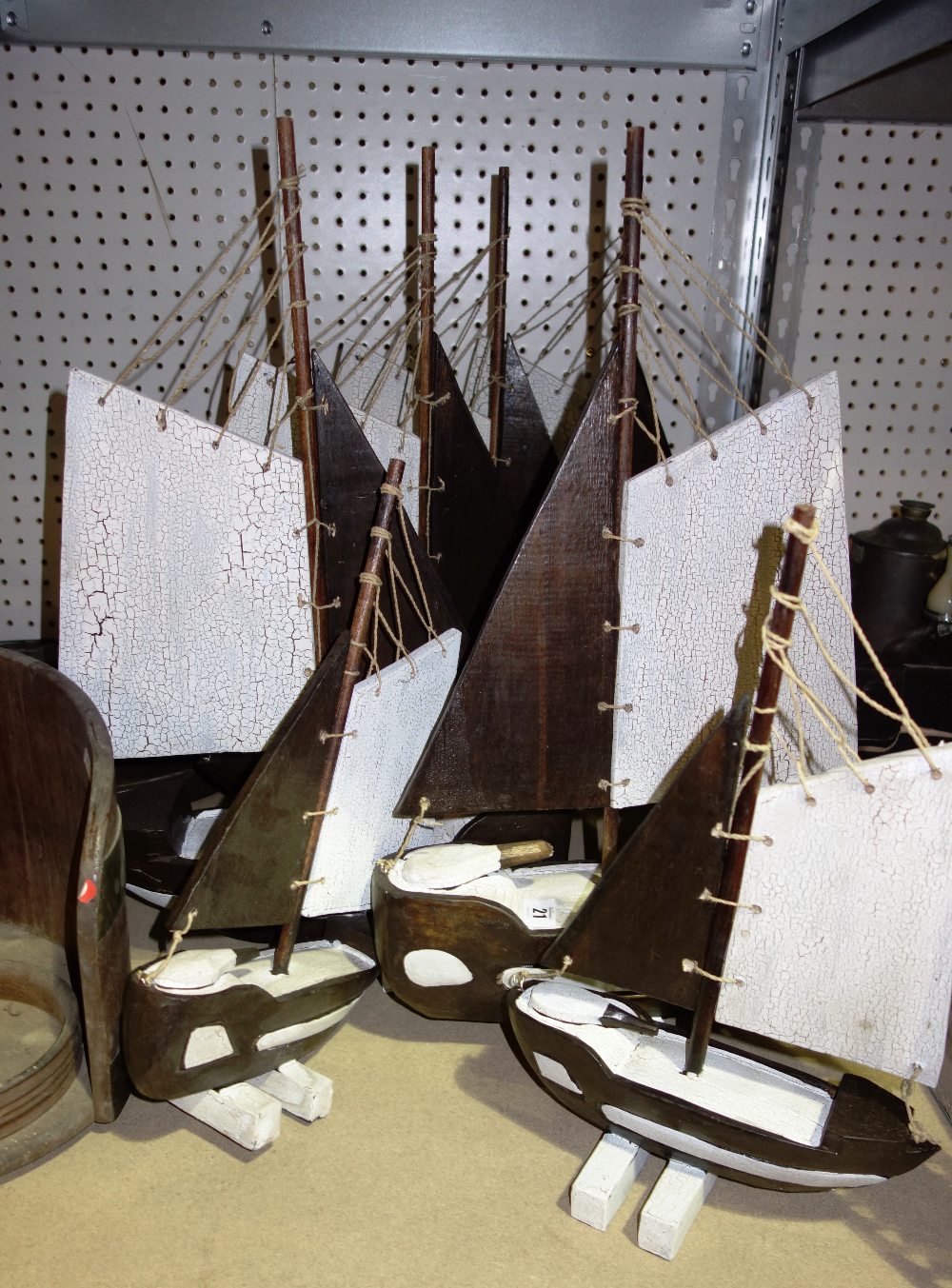 A quantity of 20th century black and white painted wooden boats.  SH8