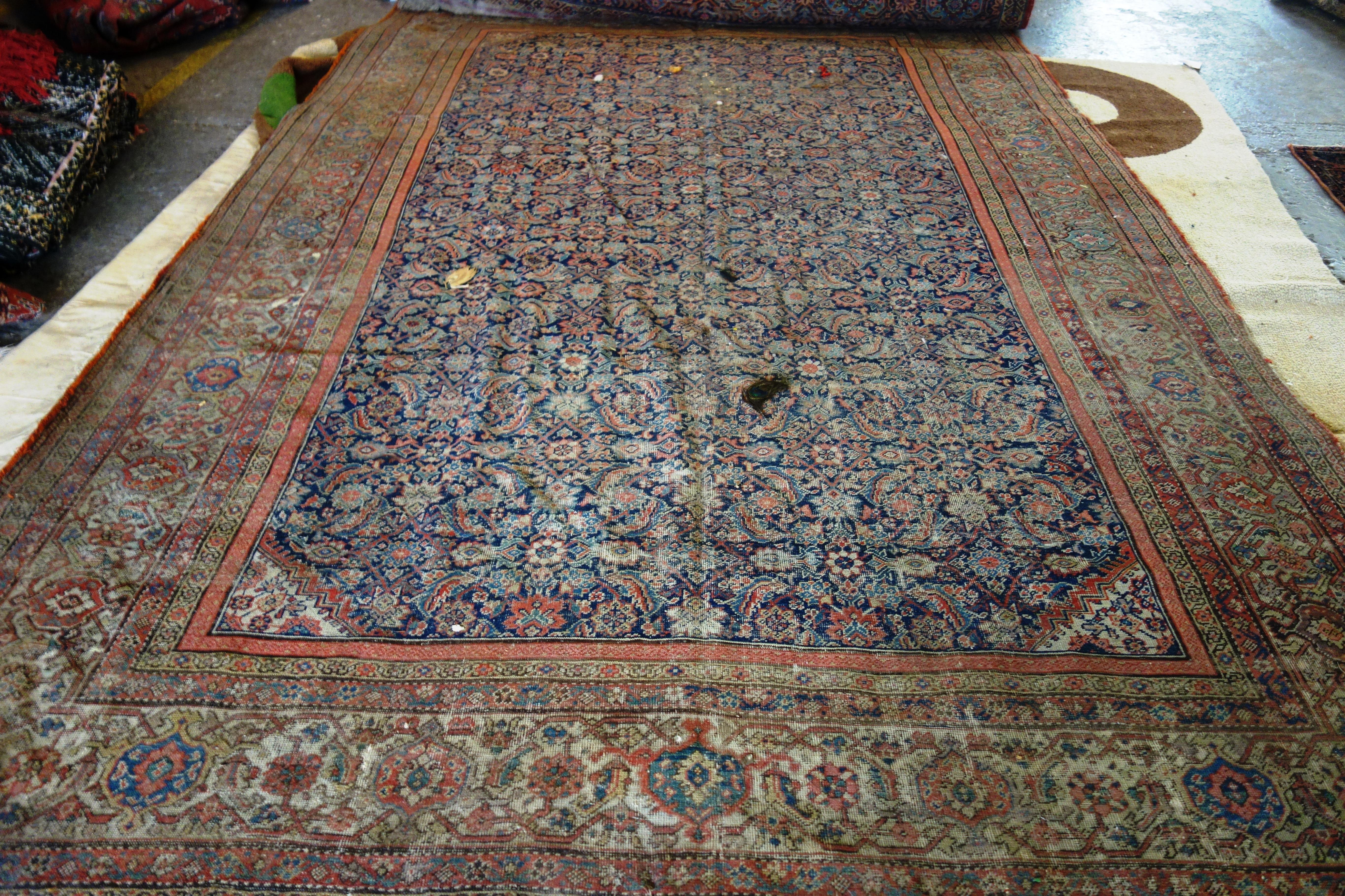 A Fereghan carpet, 373cm x 237cm, (a.f). E2