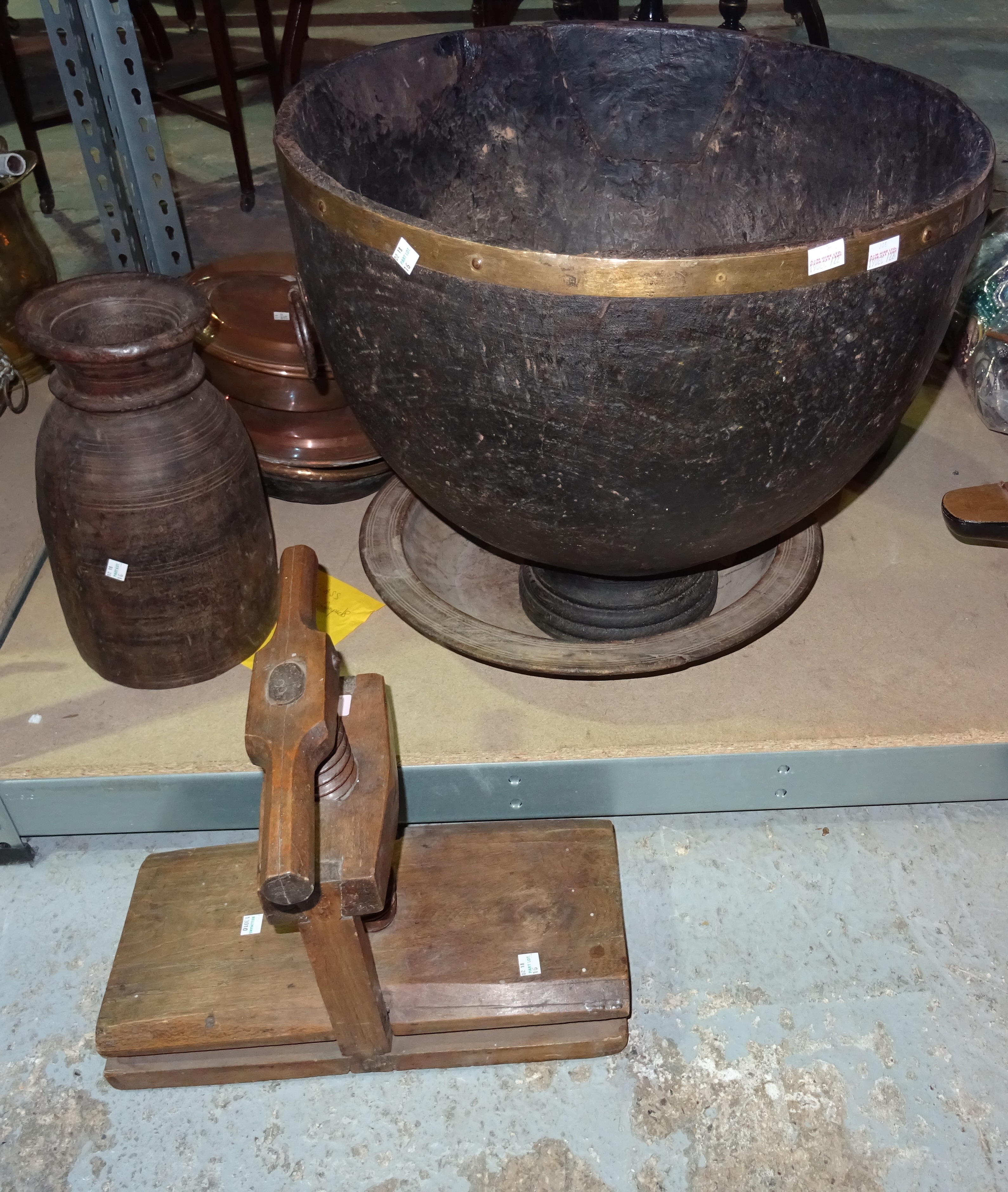 A 19th century oak flower press, a hardwood shallow bowl, a deep hollow carved hardwood bowl with brass rim and a wooden vase, (4).  S2