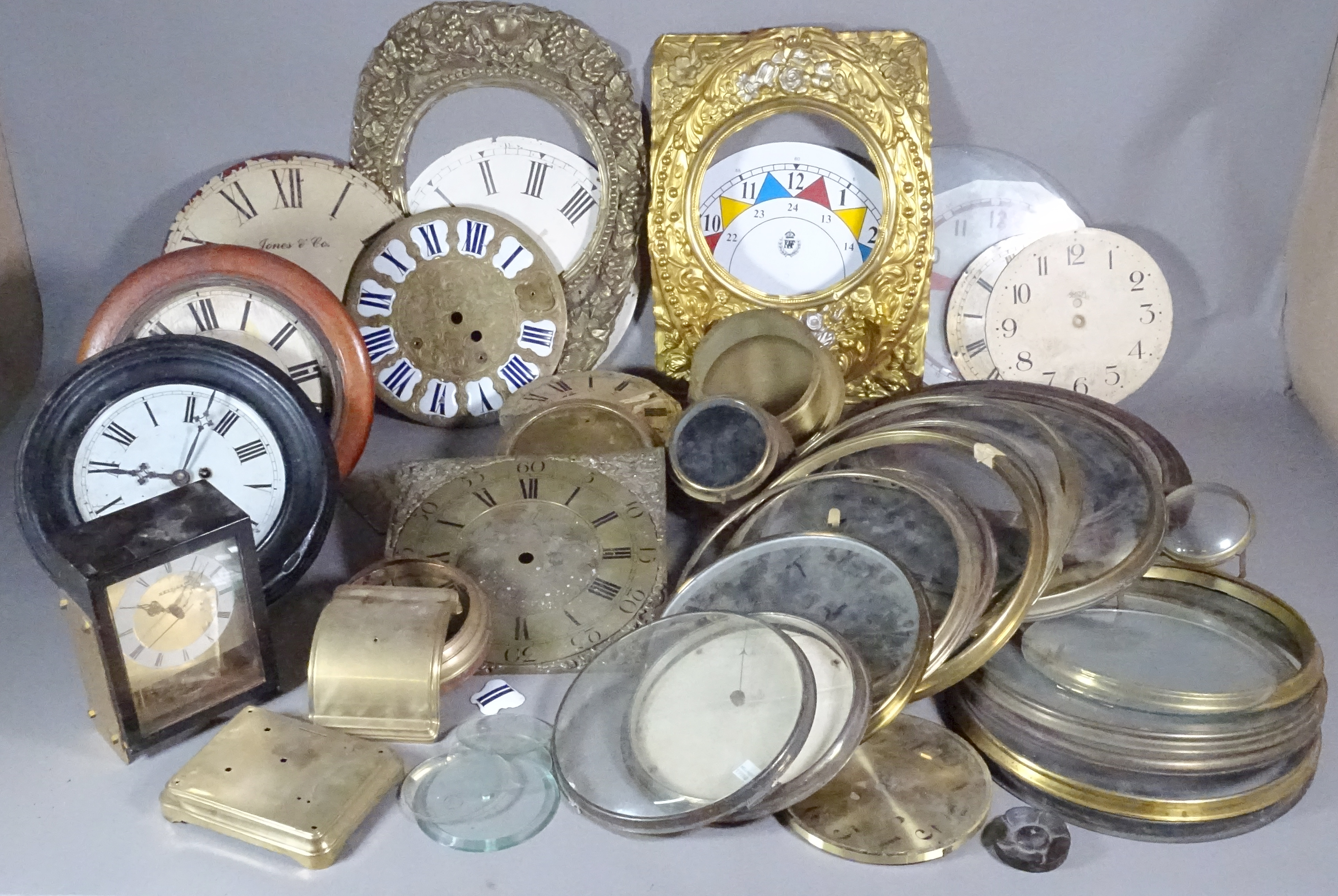 A large group of longcase and dial clock fixtures, glazed bezels and sundry, (qty).  S4B