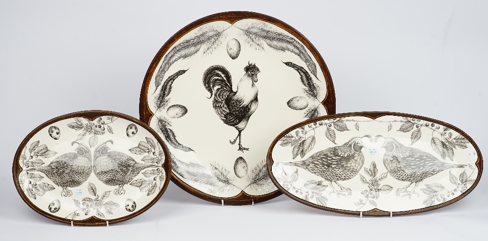A Laura Zindel large circular dish, decorated with a chicken and eggs and two graduated oval dishes with game birds (3).