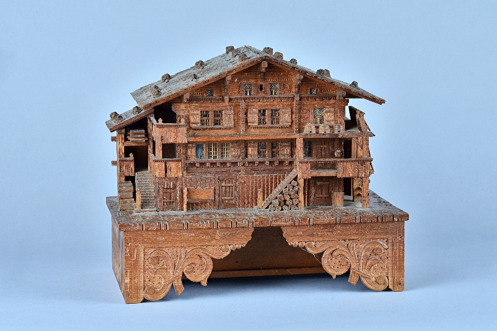A charming Swiss fruitwood and softwood musical box in the form of a chalet  Circa 1896    The musical movement playing six airs, with automatic selec