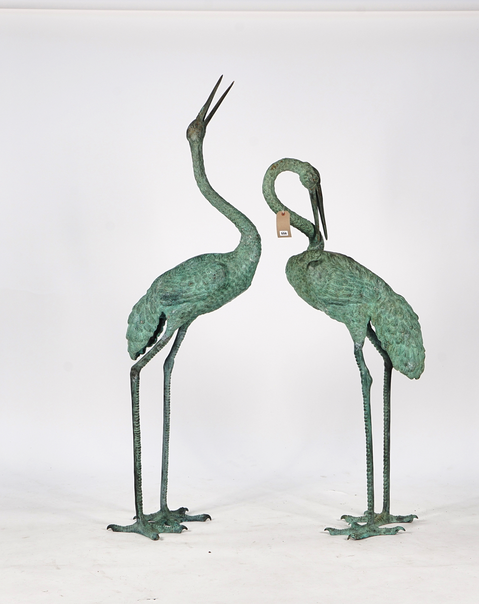 A PAIR OF BRONZE STORKS