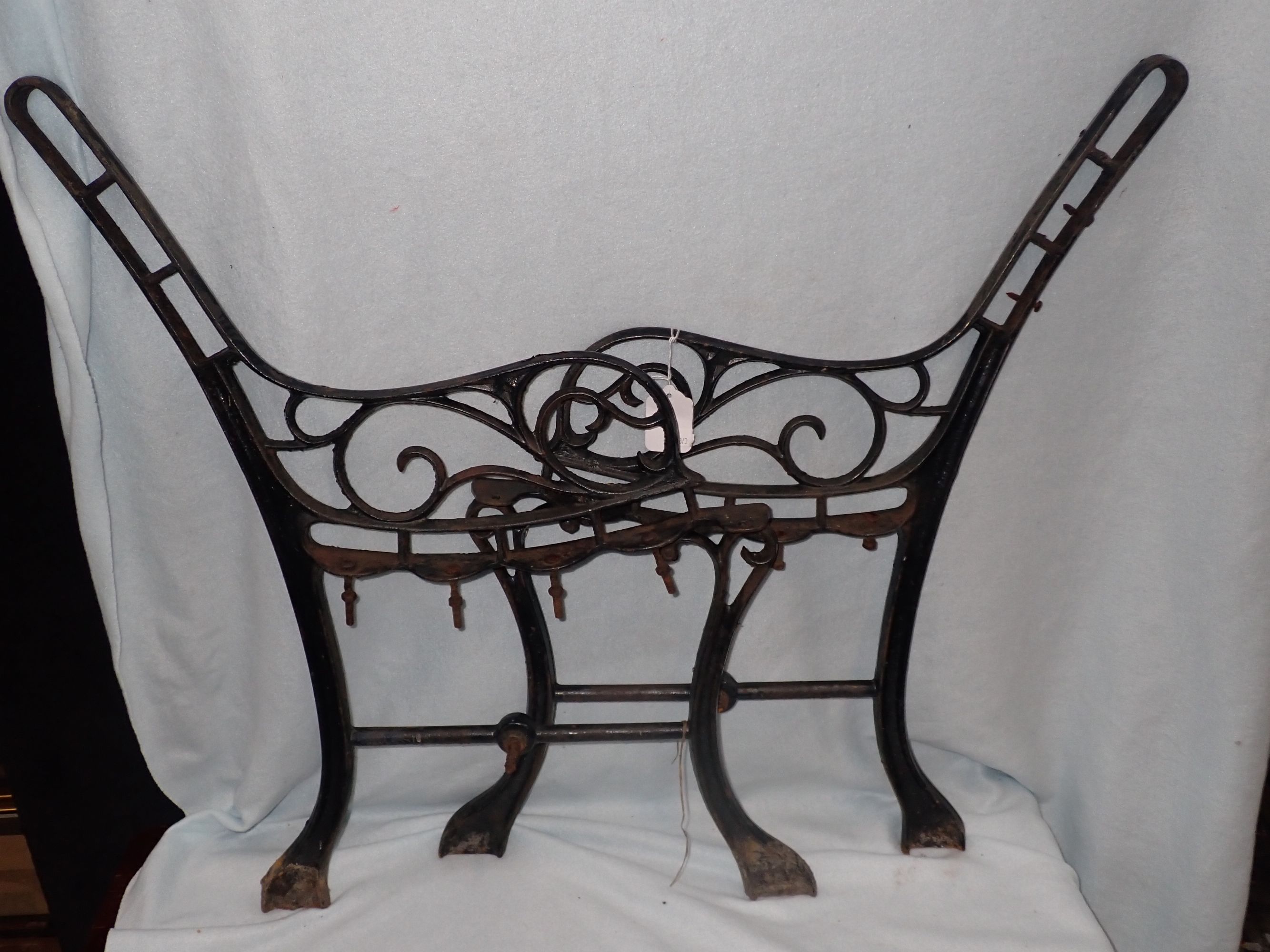 A PAIR OF VICTORIAN STYLE CAST IRON BENCH ENDS