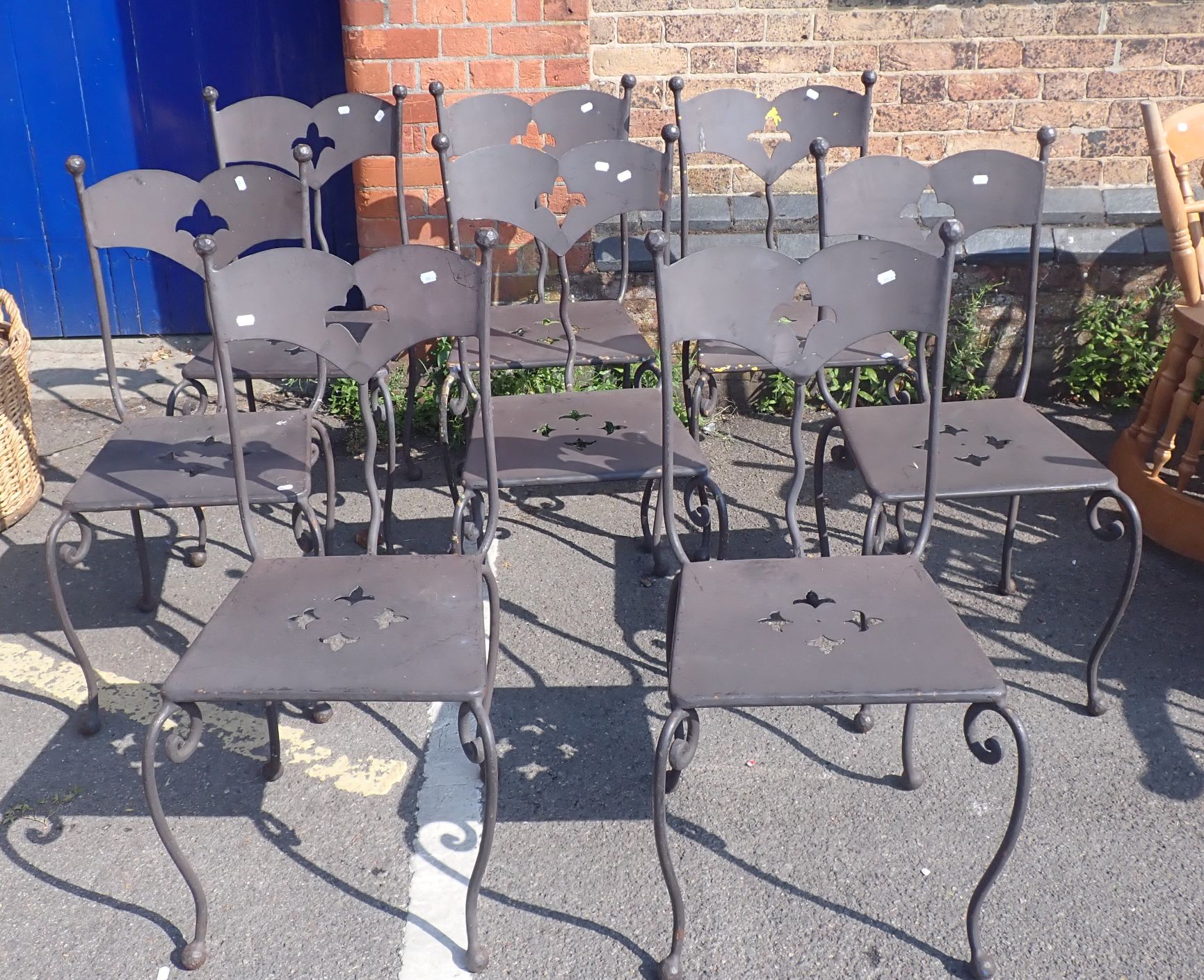 A SET OF EIGHT WROUGHT AND PIERCED METAL GARDEN CHAIRS