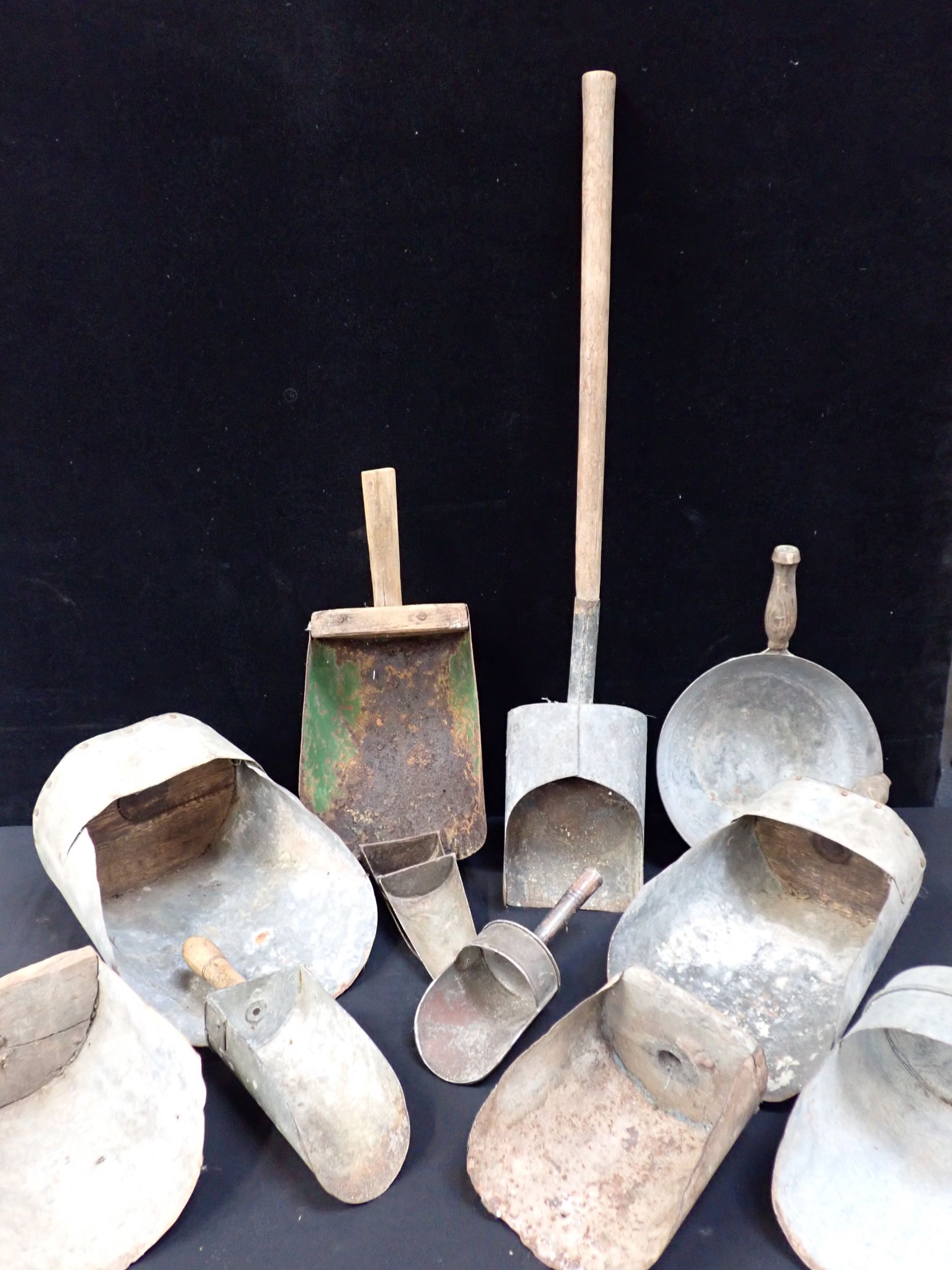A COLLECTION OF TIN GRAIN SCOOPS