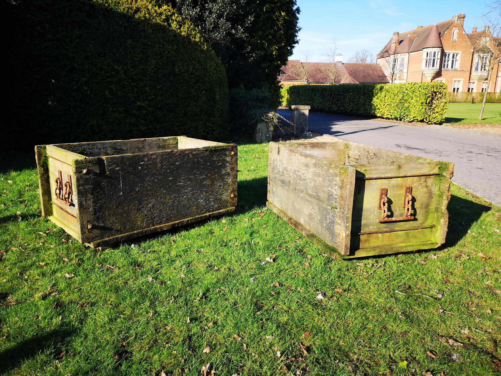 A pair of unusual iron mounted elm rectangular planters early 20th century  each with drainage hole 74cm high by 146cm long by 85cm deep