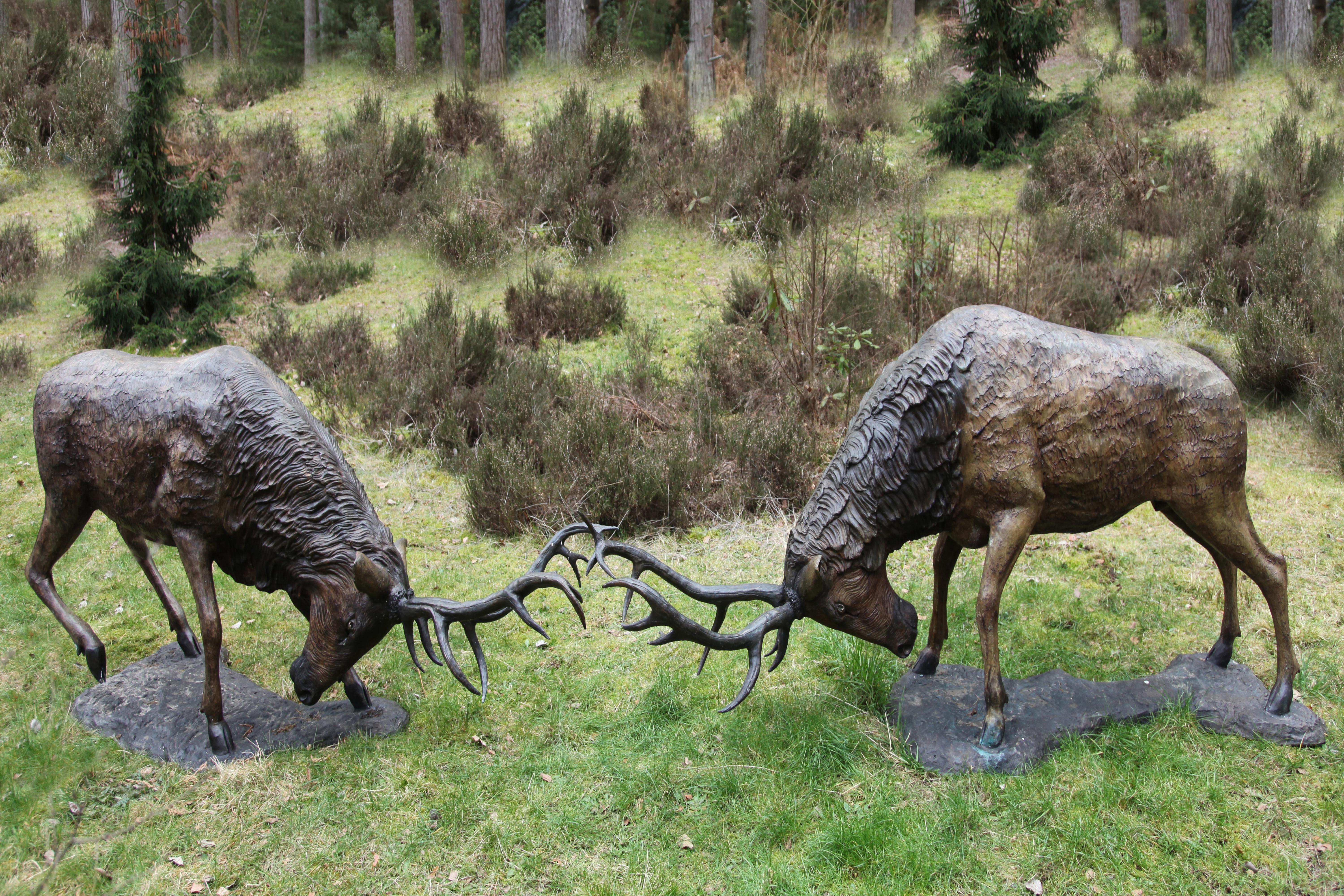 John Cox, Born 1941 A pair of red deer stags Bronze with a variegated red-brown patination 260cm long by 110cm.high and 234cm long by 107cm high