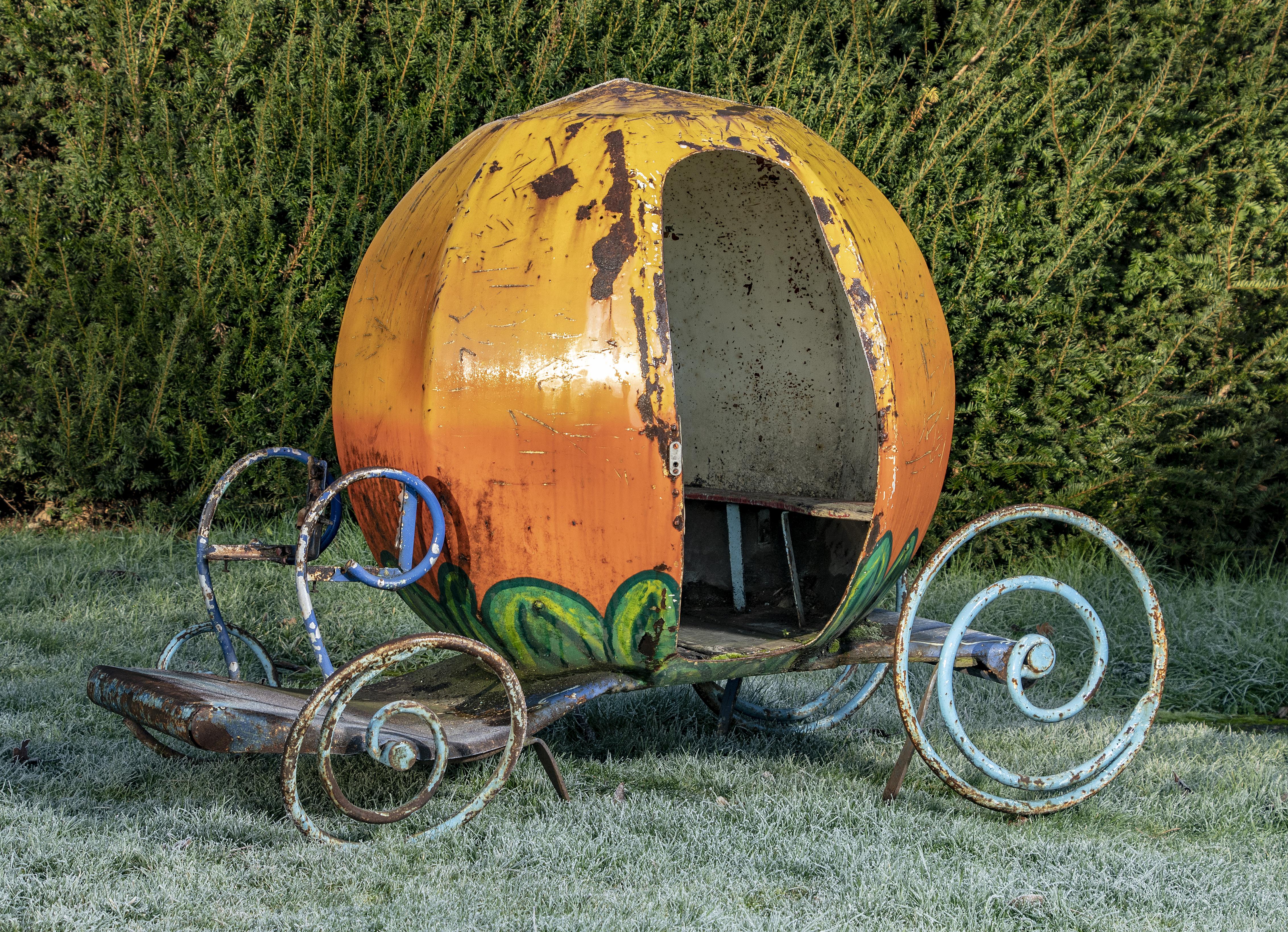A fairground ride in a form of a Cinderella-type pumpkin carriage early 20th century painted iron 115cm high by 150cm long