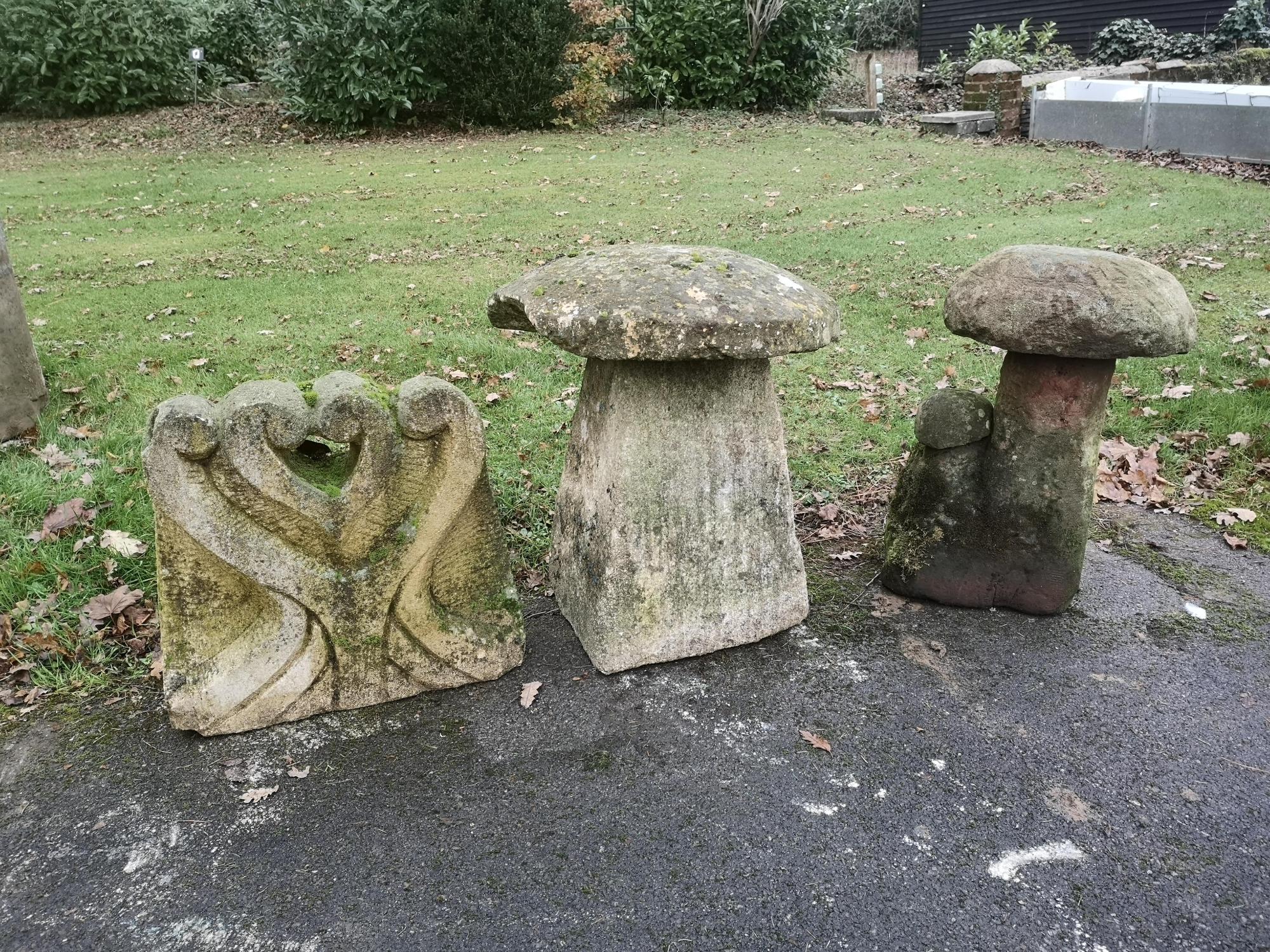 A carved Cotswold stone staddlestone 67cm high, together with a carved sandstone mushroom group and a carved limestone relief carving of a stylised...