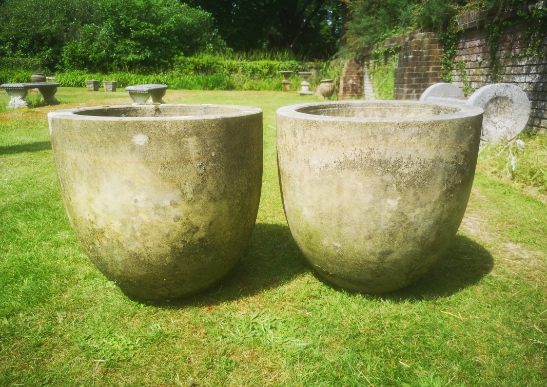 †A pair of carved sandstone planters modern 51cm high 