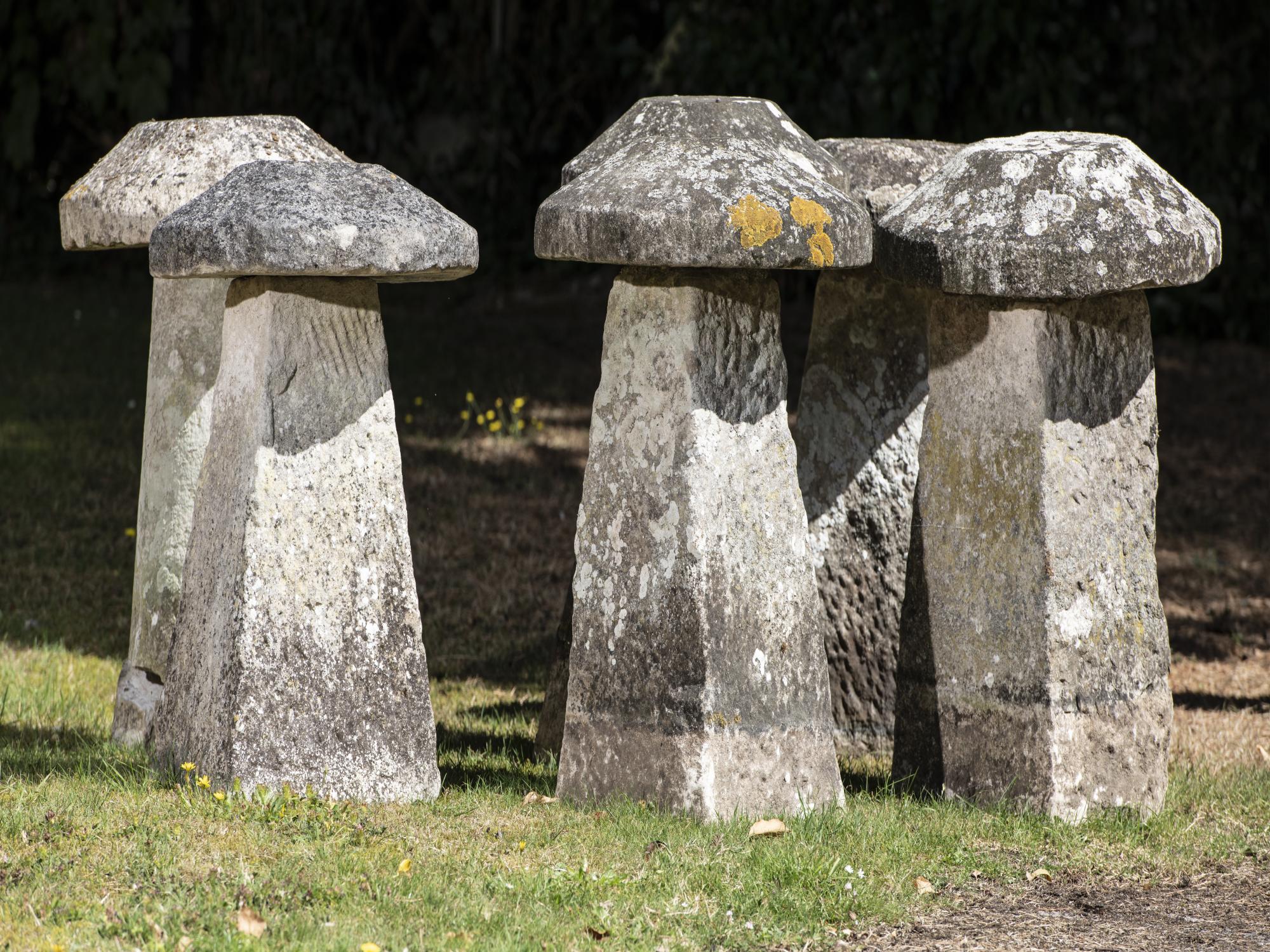 A harlequin set of six carved limestone staddlestones average height 60cm