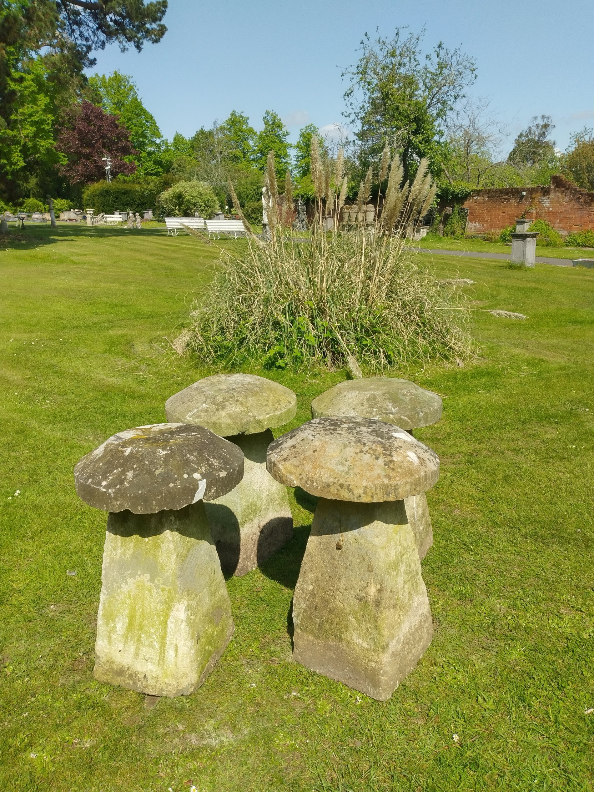A set of four similar staddlestones