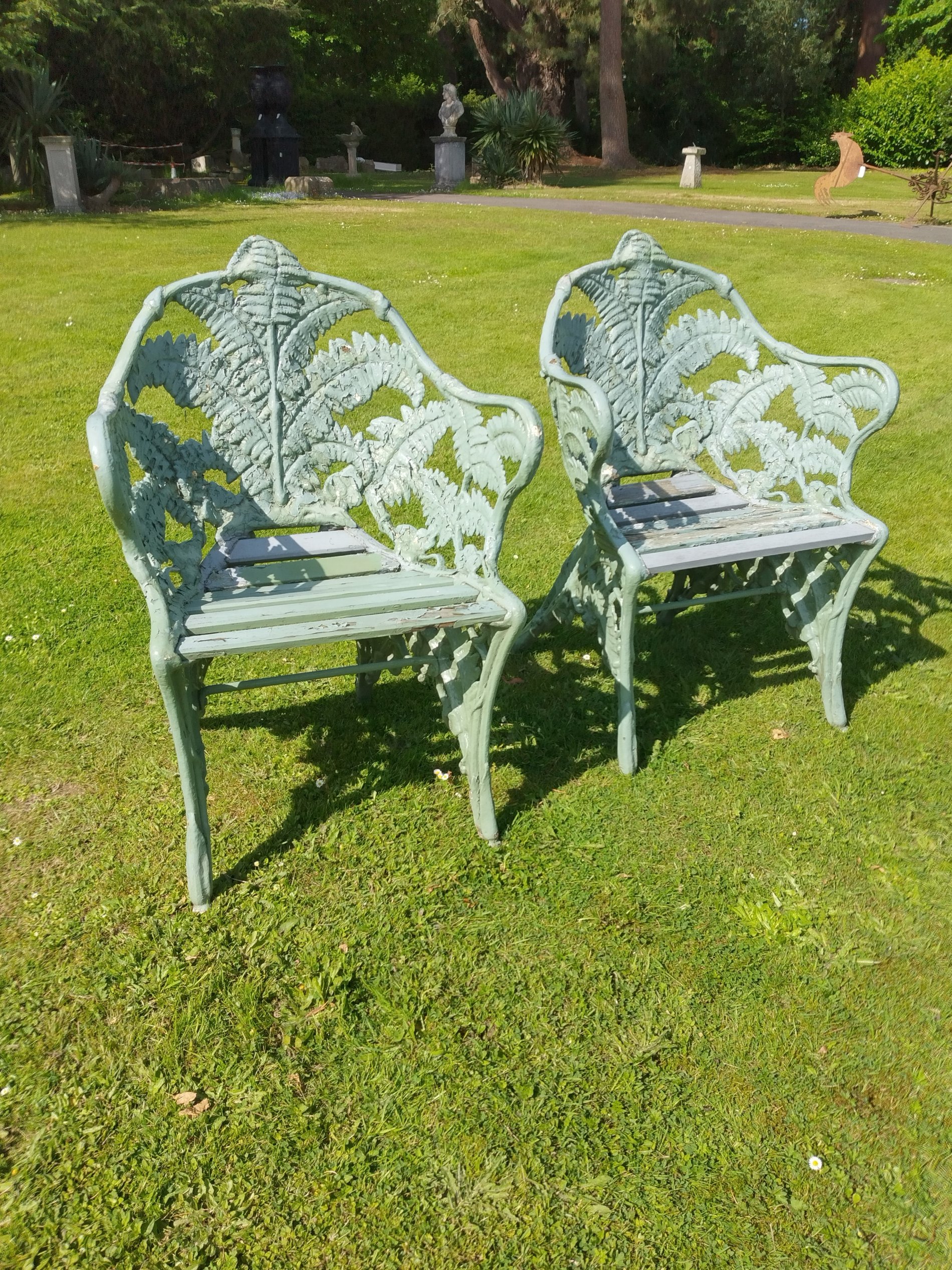 A pair of Coalbrookdale Fern and Blackberry pattern cast iron chairs