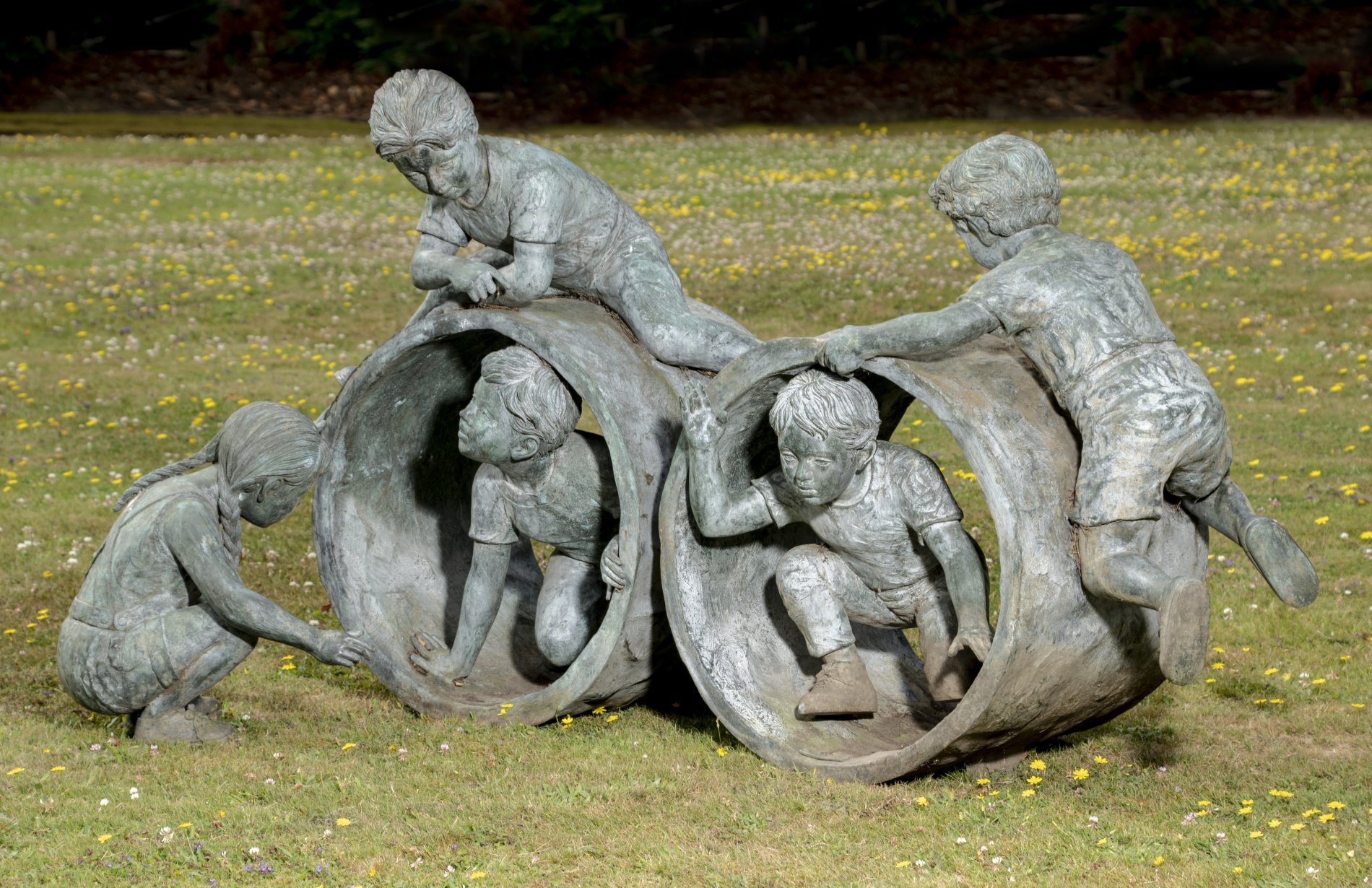 Eneri Prosperi: An Henri Studio bronze group of children playing inside pipe sections