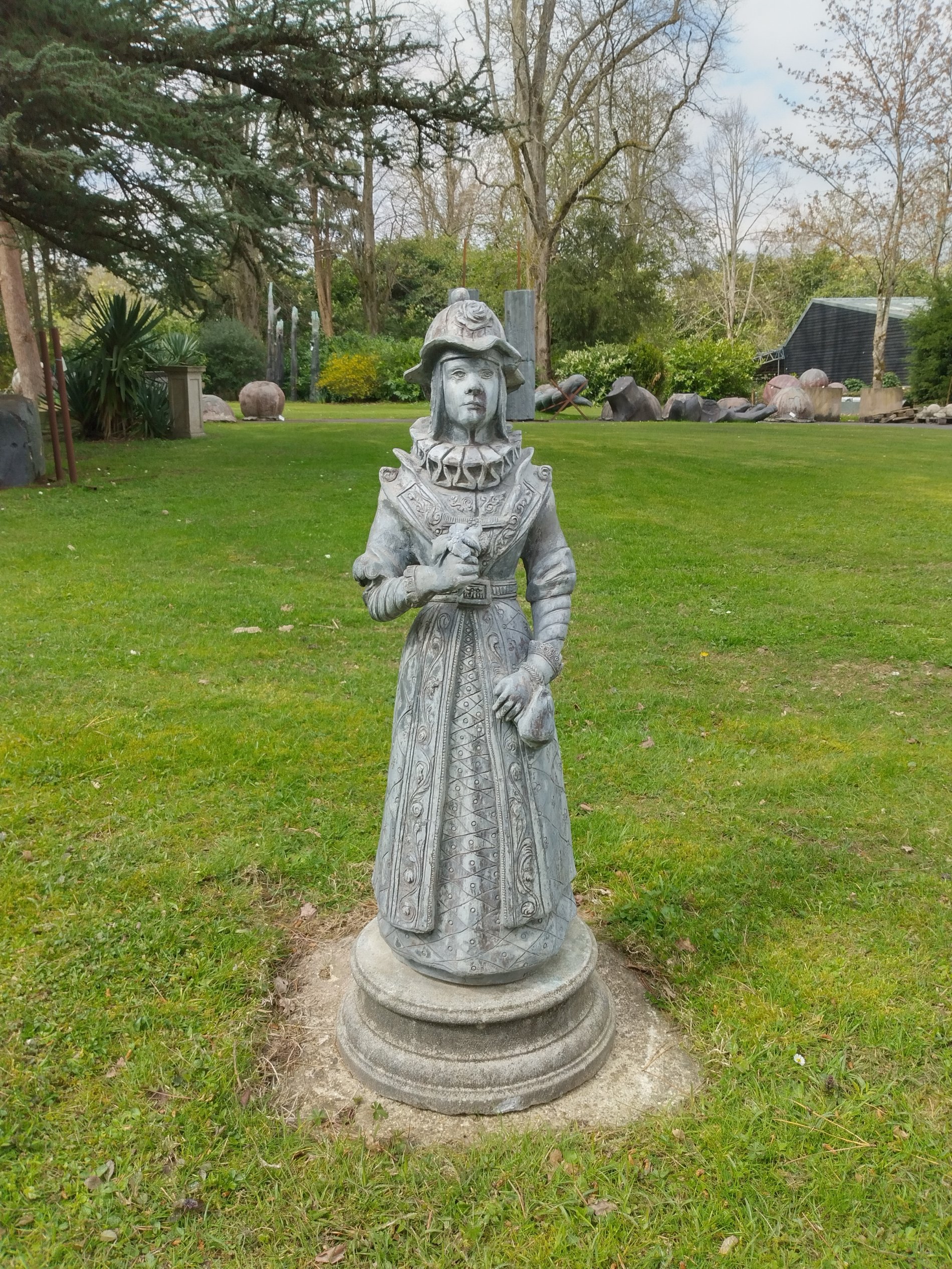 A figure of an Elizabethan girl on base