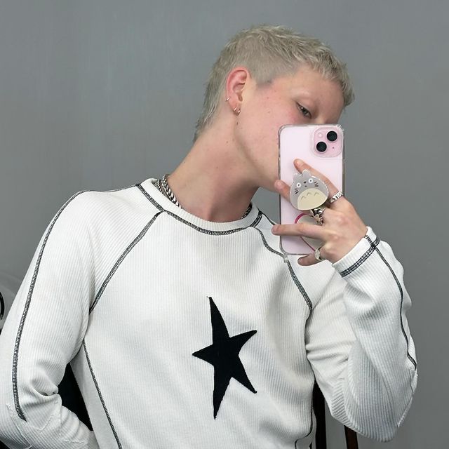 😌 buuuuutttt i’m shy 👉🏻👈🏻
‌
thanku @petterire for my new cut and colour ~ ilu
wearing @jadedldn 
‌
[ID: slim white nonbinary person hiding their face with their pink phone. they look slightly to the side. they are wearing a white and black long sleeve top with a star on the front. they have just had their hair bleached into a white blond. their hair is short and styled with some texture in it.]
‌