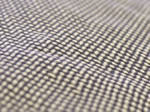 Close-up shot of a pet bed fabric, showing the intricate weave of heavy-duty canvas, emphasizing its resistance to wear and tear, with a tiny, subtle scratch mark to highlight real-world durability.