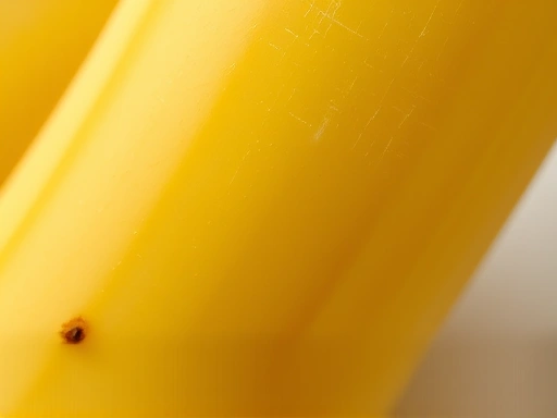 Macro shot of a banana's texture, showing subtle lines and a small segment, emphasizing its natural wholesome quality, with a blurred background.
