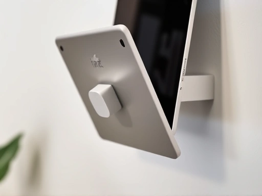 Close-up of a sleek wall-mounted tablet holder, showcasing its minimalist design and secure grip.
