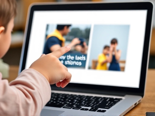 A close-up shot of an elementary school child's hands pointing at a brightly designed presentation slide on a laptop, showing a large, clear image and minimal English text. The focus is on the child actively engaging with the English presentation materials.