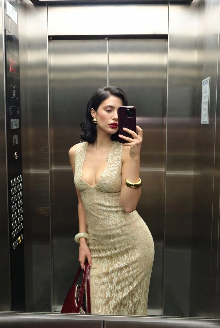 Elegant Mirror Selfie in Stainless-Steel Elevator