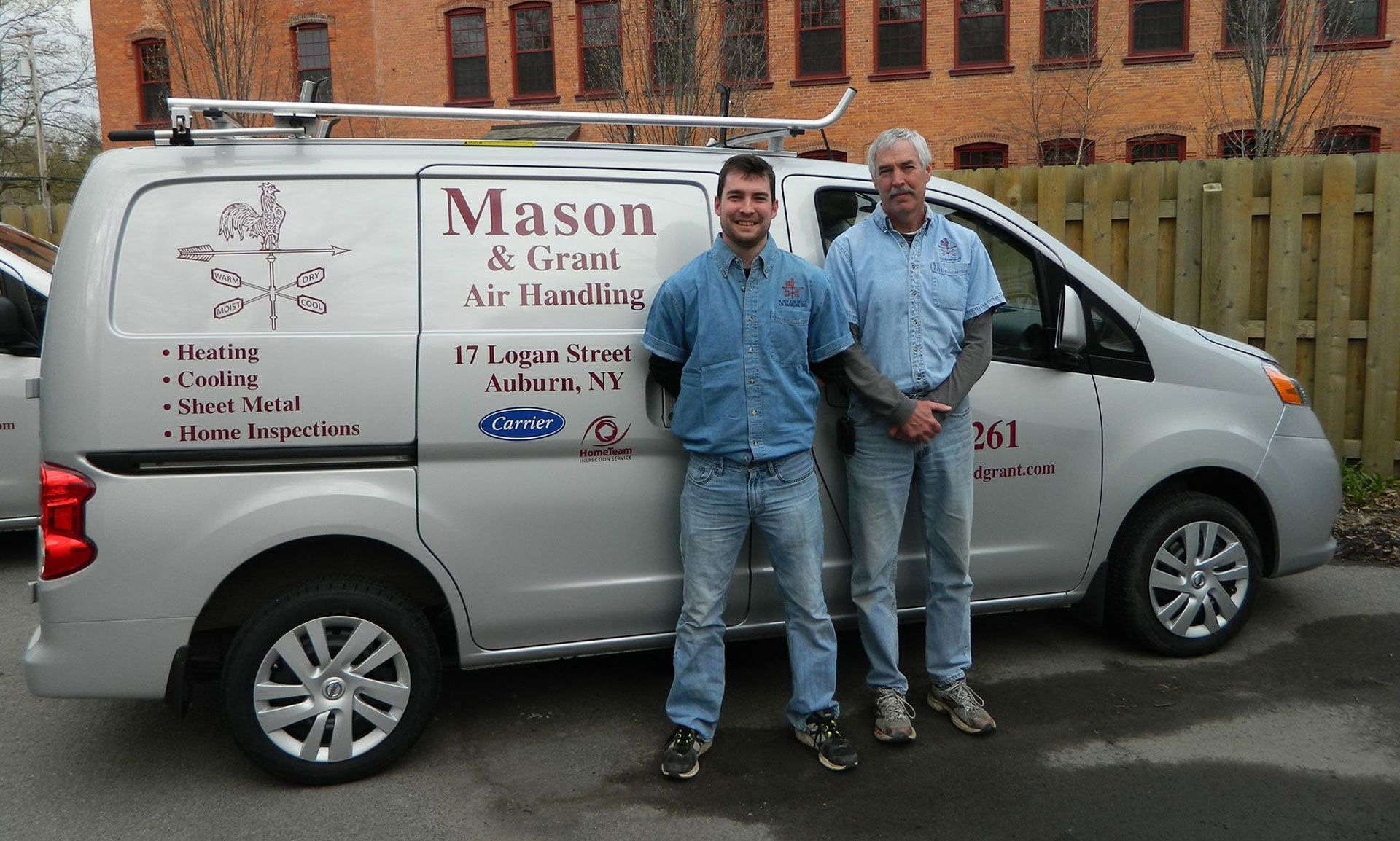 Chris and Wayne in front of company vehicle