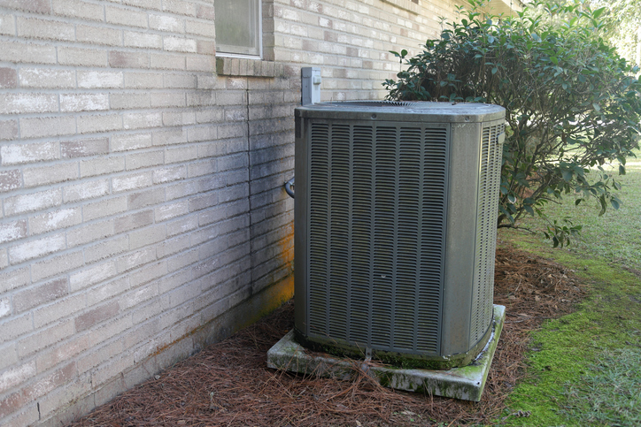 man repairing an air conditioning unit