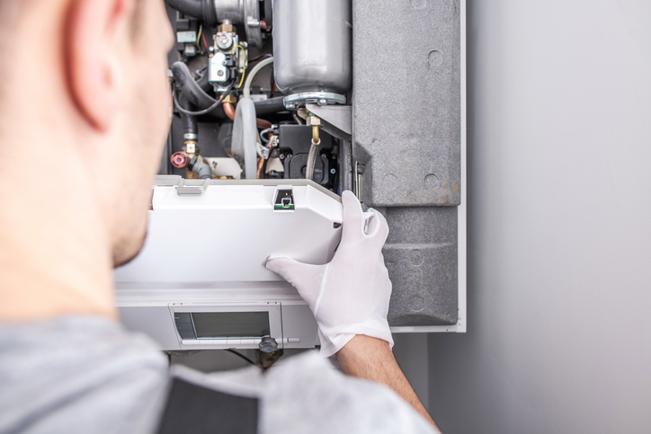 man repairing an air conditioning unit