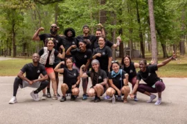 a group of people in front of a camp ground for afrotech being themselves