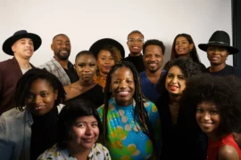 a group of black individuals together taking a photo and smiling