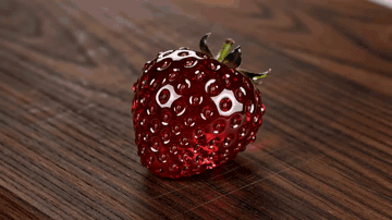 AI-generated ASMR video of a knife slicing a glass strawberry with synced impossible audio