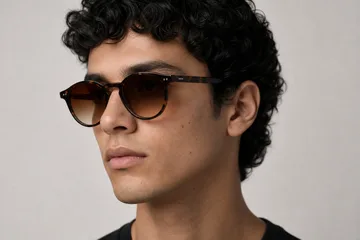 Glasses, jewellery and headphones placed on a generated model face and head