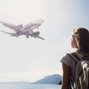 Girl watches plane in sky to show travel anxiety