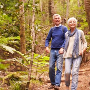 Mature couple walks in woods