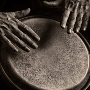 Man's hands playing drums