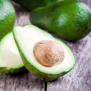 Fresh cut avocado on wood surface