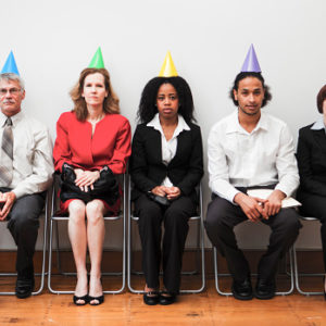 A group of business colleagues sitting awkwardly at an office party