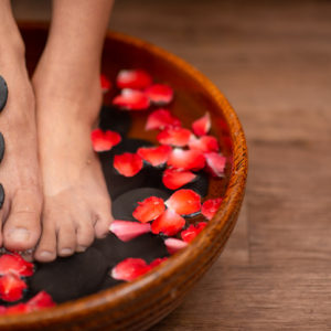 Beautiful female feet at spa soaking for foot care