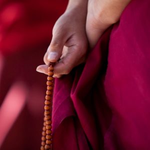 Monk holding mala beads