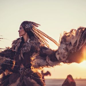 Woman dancing with feathers at Burning Man
