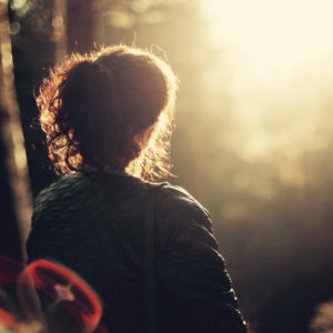 Woman thinking in a forest