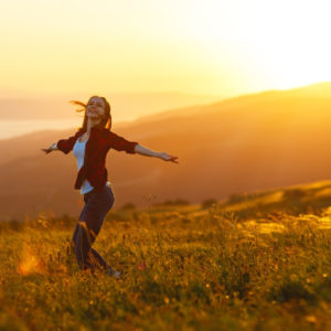 Woman dancing at sunset