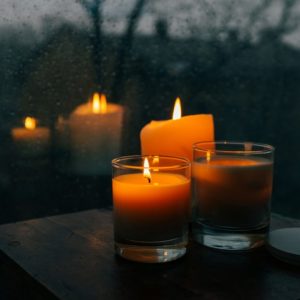 Meditation candles and blanket on wood surface