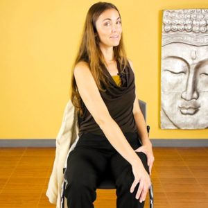 Woman demonstrating chair yoga pose